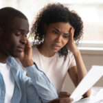 Troubled,Pensive,Biracial,Young,Couple,Feel,Disappointed,Consider,Paperwork,Paying